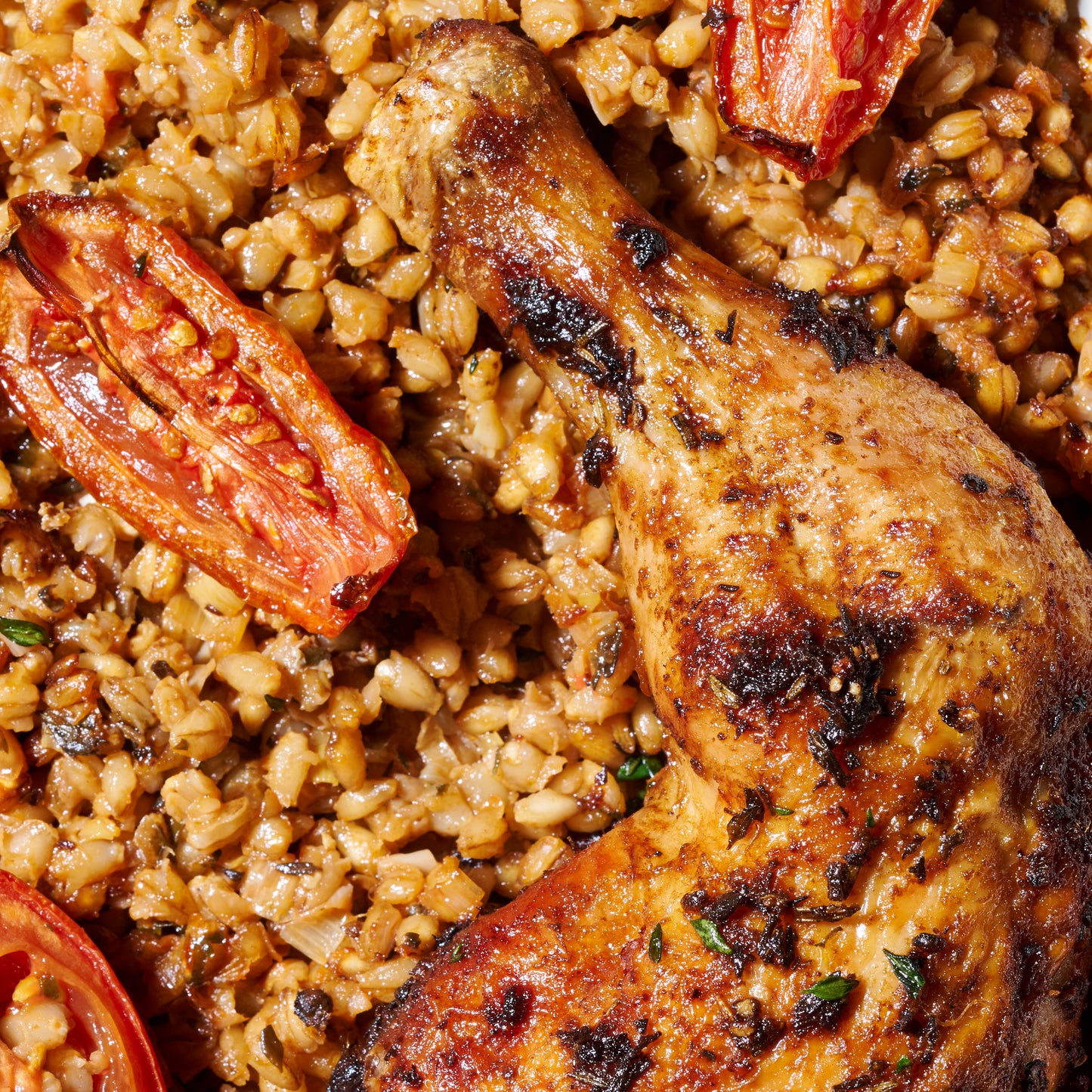 Roast chicken marylands with pearl barley, leek and roasted tomatoes